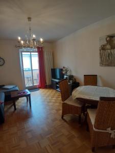 a living room with a table and chairs and a dining room at Wohnung mit Blick über Potsdam in Potsdam