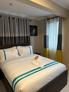 a large bed with a flower on top of it at Mansah Plus Hotel and Apartments in Accra +23 photos