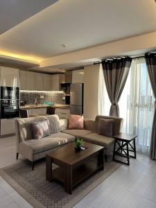 a living room with a couch and a table at Mansah Plus Hotel and Apartments in Accra