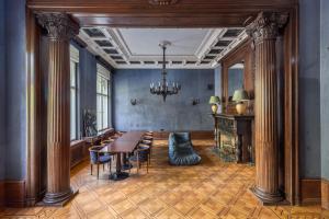 a dining room with a table and chairs and a chandelier at The Benjamin House in Rīga
