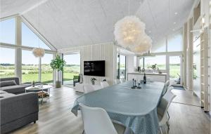 a living room with a dining table and a couch at 4 Bedroom Nice Home In Odder in Odder