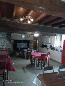 a kitchen and dining room with a table and chairs at Le Marquis De La Guintre in Courtils