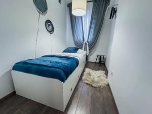 a bedroom with a bed and a window with a rug at Istria Symphony Apartment in Labin