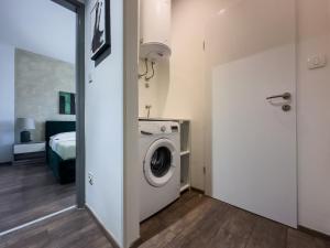 a bathroom with a washing machine in a room at Istria Symphony Apartment in Labin