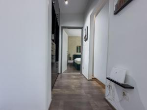 a hallway with white walls and a long hallway at Istria Symphony Apartment in Labin +8 photos