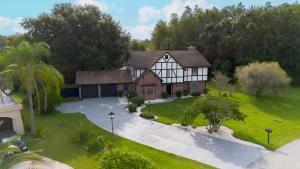 an aerial view of a house with a driveway at Orlando Getaway 6br Retreat W Pool & Fireplace in Kissimmee