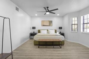 a white bedroom with a bed and a ceiling fan at Orlando Getaway 6br Retreat W Pool & Fireplace in Kissimmee +27 photos