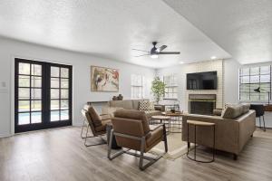 a living room with a couch and chairs and a tv at Orlando Getaway 6br Retreat W Pool & Fireplace in Kissimmee