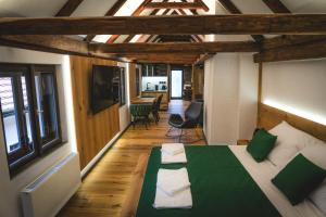 a bedroom with a bed with a green comforter at Parkan 127 Apartments in Český Krumlov
