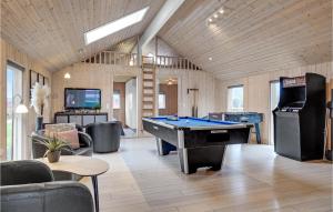 a living room with a pool table and a tv at Nice Home In Sydals With Sauna in Høruphav