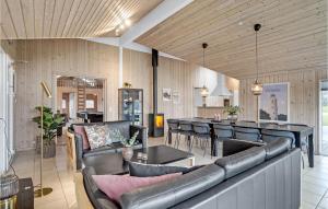 a living room with black leather furniture and a table at Nice Home In Sydals With Sauna in Høruphav