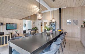 a large dining room with a table and chairs at Nice Home In Sydals With Sauna in Høruphav