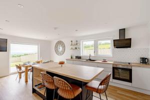 una cucina con un grande tavolo e sedie in legno di Berryrigg Cottage a Dumfries Altre 29 foto