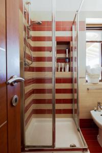 a bathroom with a shower with red and white stripes at Vista mare Fiumicino-Beach&Fly Stay in Fiumicino