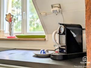 a coffee maker sitting on a counter next to a window at Le Spacieux - Vue Loire - Queen Size - Free Parking in Orléans