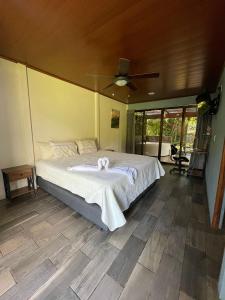 a bedroom with a bed with towels on it at El Castillo Harmony in El Castillo de La Fortuna