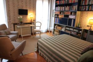 a bedroom with a bed and a desk and a book shelf at Casa Fracasso in Verona