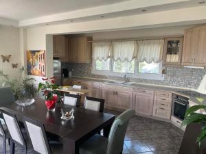 a kitchen with a table and chairs and a dining room at Palio Luxury Apartment in Paleo Tsifliki +4 photos