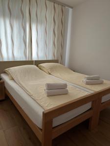 a bed with two towels on top of it at Una La Unica in Bihać