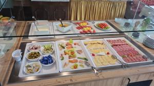a buffet with many different types of food on display at Hotel Donnerhof in Fulpmes