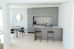 a kitchen with a counter and a table at C House Rooms Lake in Peschiera del Garda