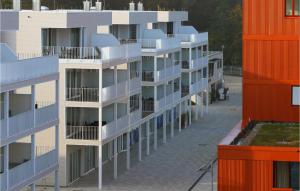 a row of apartment buildings with orange and white balconies at Priwallpromenade 27, Whg 5 in Priwall