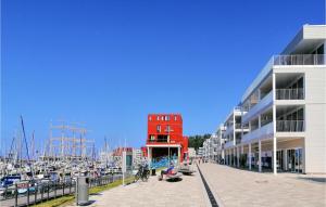 a marina with a red building and many boats at Priwallpromenade 27, Whg 5 in Priwall