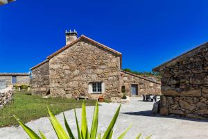 a stone building with a chimney on top of it at Casa de Valente - Camariñas in Camariñas