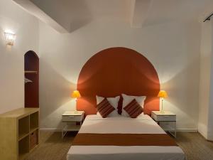 a bedroom with a large bed and two night stands at La Villageoise in Aups
