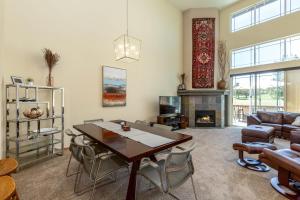 a living room with a table and a fireplace at Spacious 4BR Private HOT TUB Eagle Crest Resort on Golf Course in Redmond