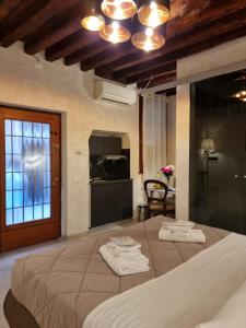 a bedroom with a large bed with two towels on it at San Marco 3097 - LuxuryJacuzzi in Venice