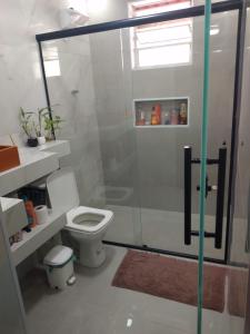 a bathroom with a toilet and a shower at Casa da Marcinha in Sao Paulo