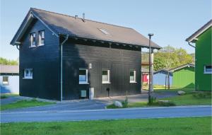 a black building with a brown at Ferienhausdorf Thale in Thale