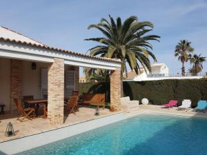 a villa with a swimming pool and a house at Villa Los Balcones in Torrevieja