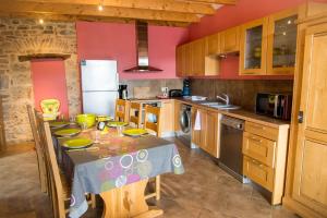 a kitchen with a table with a table cloth on it at Gîte "la nature" in La Canourgue