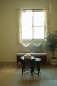 a living room with a bench and a window at Maru in Tainan