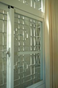 a glass door with a window in a bathroom at Maru in Tainan +37 photos