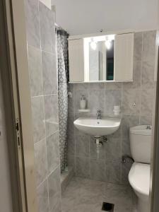 a bathroom with a sink and a toilet at Vino suites in Agia Anna Naxos