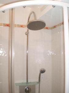 a shower with a shower head in a bathroom at Gîte Maison Cavalier 2/4 personnes à Gabriac in Gabriac