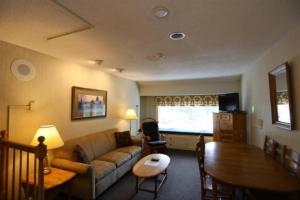 a living room with a couch and a table at Inns of Waterville Valley 309 in Waterville Valley