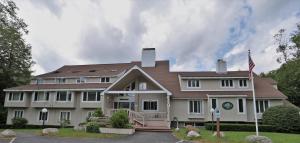 a large house with a flag in front of it at Inns of Waterville Valley 309 in Waterville Valley