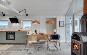 a kitchen and dining room with a table and chairs at Stunning Home In Ulfborg With Kitchen in Ulfborg