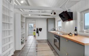 a kitchen with a sink and a counter top at Stunning Home In Ulfborg With Kitchen in Ulfborg +22 photos