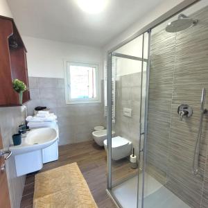a bathroom with a shower and a sink and a toilet at Castello Mountain Lake Iseo Hospitaty in Bossico +29 photos