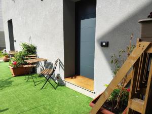 a patio with a table and chairs and a door at A Casa Mia 2.0 in Saronno +11 photos