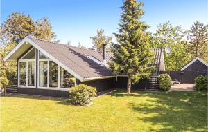 a house with a roof and a yard at Gorgeous Home In Hemmet With Wifi in Hemmet