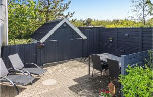 a backyard with a black fence and a table and chairs at Gorgeous Home In Hemmet With Wifi in Hemmet +20 photos