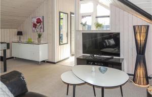 a living room with a tv and a table at Gorgeous Home In Hemmet With Wifi in Hemmet