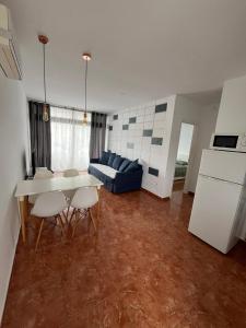 un soggiorno con un tavolo e un divano blu di las Piteras ad Arona