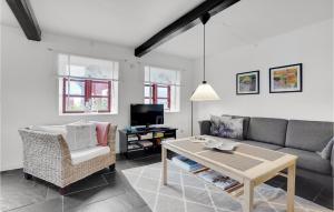a living room with a couch and a table at Two-Bedroom Holiday Home Sydals With A Fireplace 03 in Vollerup